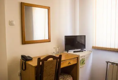 a room with a desk with a computer and a television at Family Hotel Saint Iliya in Burgas City