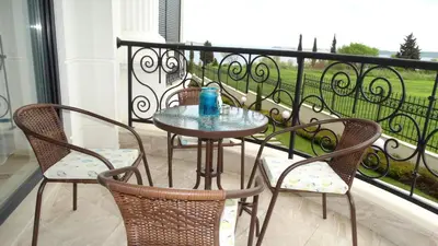 a table and two chairs on a balcony at July's Island Deluxe in Chernomorets