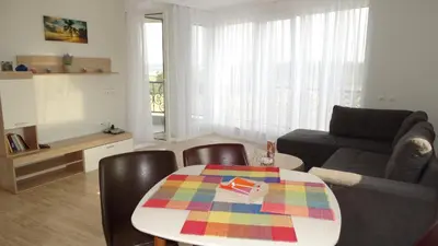 a living room with a table and a couch at July's Island Deluxe in Chernomorets