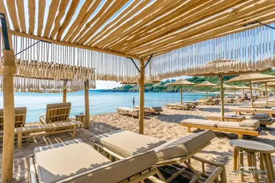 a group of chairs and umbrellas on a beach at July's Island Deluxe in Chernomorets