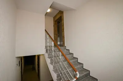 a staircase in a house with a metal railing at Апартаменти 