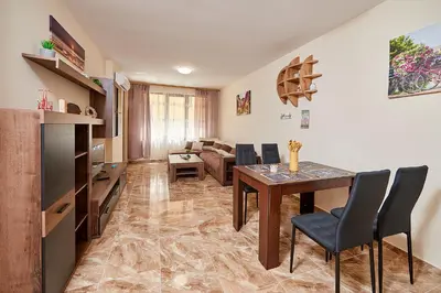 a living room with a table and chairs and a couch at Апартаменти 