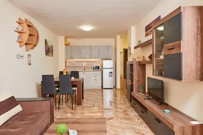 a living room with a couch and a dining room at Апартаменти 