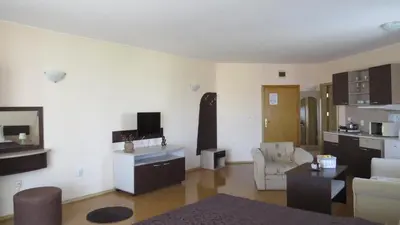 a living room with a couch and a table at Apart Hotel Vechna R in Sunny Beach
