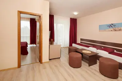 a living room with a couch and a table in a room at Apart Hotel Vechna R in Sunny Beach