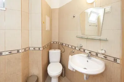 a bathroom with a toilet and a sink at Apart Hotel Vechna R in Sunny Beach