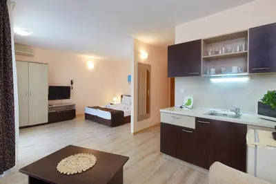 a living room with a kitchen and a bedroom at Apart Hotel Vechna R in Sunny Beach