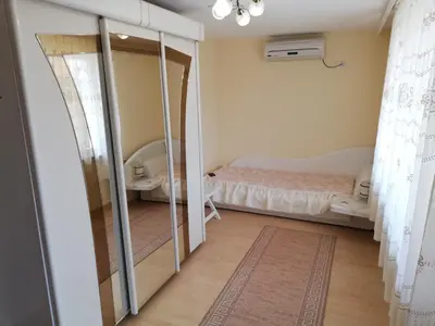 a bedroom with a bed and a mirror at апартамент Росен in Nesebar