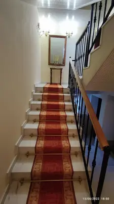 a flight of stairs with a mirror on the wall at апартамент Росен in Nesebar
