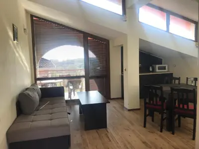 a living room with a couch and a table at Апартхотел Созополски перли in Sozopol