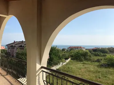 a view of the ocean from the balcony of a house at Апартхотел Созополски перли in Sozopol