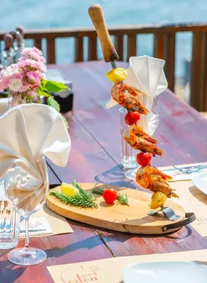 a table with shrimp skewers on a cutting board at Garden of Eden Complex in Sveti Vlas