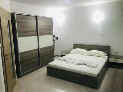 a bedroom with a bed with white sheets and pillows at PS Apartment / SunCoast Resort in Sveti Vlas