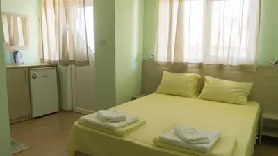 a bedroom with a bed with two towels on it at Guest House Gardeli in Tsarevo