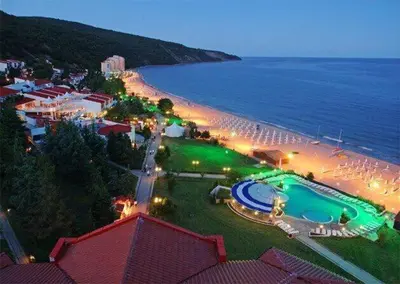 a resort with a pool and a beach at night at Private Apartment 49 in Prestige Fort Beach Hotel in Sveti Vlas