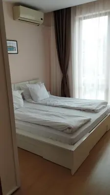 a bed in a room with a window at Private Apartment 49 in Prestige Fort Beach Hotel in Sveti Vlas