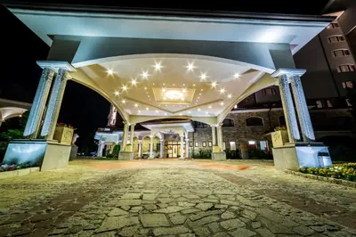 an entrance to a building at night with lights at Helena Sands in Sunny Beach