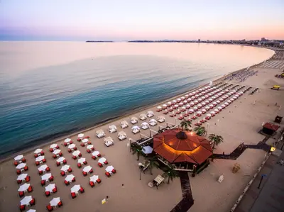 an aerial view of a beach with umbrellas and the ocean at Helena Sands in Sunny Beach