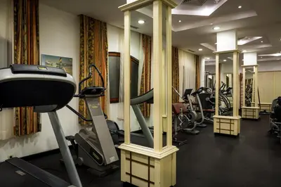a gym with a row of treadmills and machines at Helena Sands in Sunny Beach