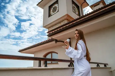 a woman standing in front of a building with a clock tower at Helena Sands in Sunny Beach