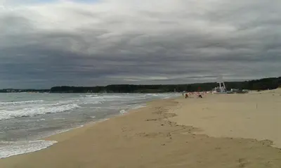 a group of people walking on the beach at Апартамент Флора - гр.Приморско ММЦ in Primorsko