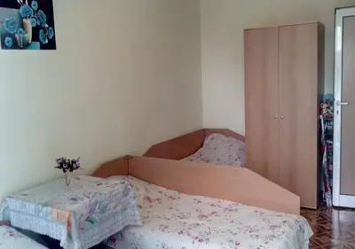 a bedroom with two beds with flowers on it at Апартамент Флора - гр.Приморско ММЦ in Primorsko