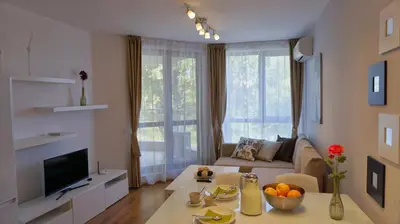 a living room with a couch and a table at Апартаменти Бяла Клиф на плажа - Apartments Byala Cliff First Line in Byala