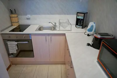 a kitchen with a sink and a counter top at Апартаменти Бяла Клиф на плажа - Apartments Byala Cliff First Line in Byala