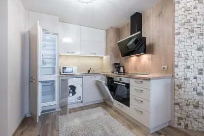 a kitchen with white cabinets and a stove top oven at Apartments Cats in Varna City