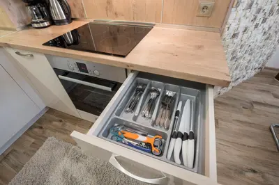 a kitchen with a drawer full of knives at Apartments Cats in Varna City
