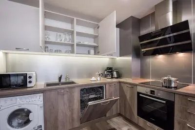 a kitchen with a washer and a dishwasher at Apartments Cats in Varna City