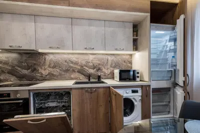 a kitchen with a sink and a washer and dryer at Apartments Cats in Varna City