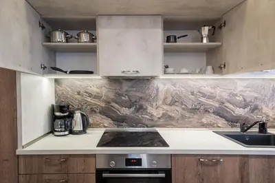 a kitchen with a sink and a stove top oven at Apartments Cats in Varna City
