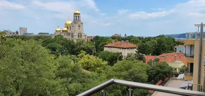 a view of a city with a church in the background at Apartments Cats in Varna City