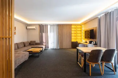 a living room with a couch and a table at Avenue Hotel Deluxe in Burgas City