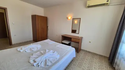 a bedroom with a white bed and a desk at SB Rentals Apartments in Royal Dreams Complex in Sunny Beach