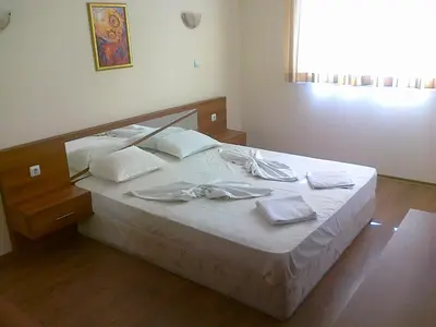 a bed with white sheets and white towels on it at SB Rentals Apartments in Royal Dreams Complex in Sunny Beach
