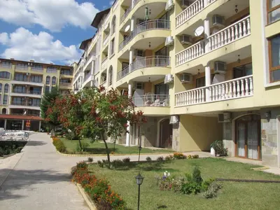a large apartment building with a garden in front of it at SB Rentals Apartments in Royal Dreams Complex in Sunny Beach