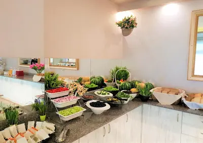 a buffet of vegetables and plants on a counter at Grenada Hotel in Sunny Beach