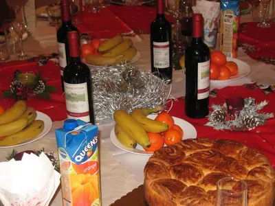 a table topped with bottles of wine and fruit at The White House in Bliznatsi