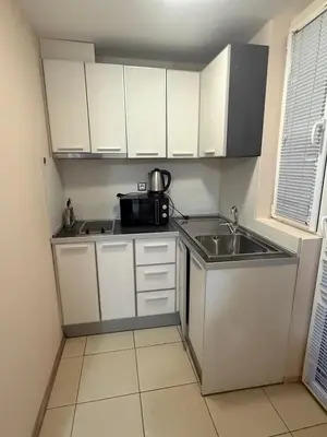 a small kitchen with a sink and a microwave at Casa Luba Sunny beach in Sunny Beach