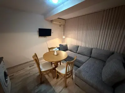 a living room with a couch and a table with chairs at Casa Luba Sunny beach in Sunny Beach