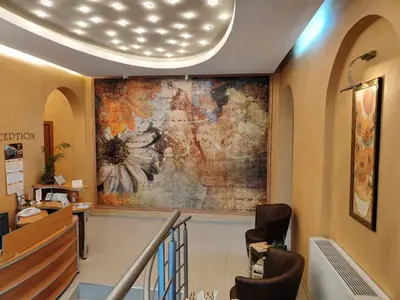 a lobby with a large painting on the wall at Семеен Хотел 