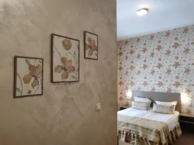 a bedroom with a bed and three pictures on the wall at Семеен Хотел 