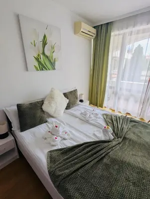 a bedroom with a bed with flowers on it at CHATEAU DEL MAR C31a Studio Sunny Beach in Sunny Beach