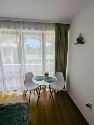 a room with a table and two chairs and a window at CHATEAU DEL MAR C31a Studio Sunny Beach in Sunny Beach