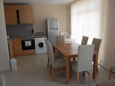 a kitchen with a dining room table and chairs at HillTop Villa in Burgas City