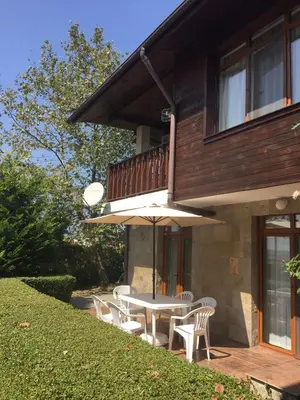 a patio with a table and chairs and an umbrella at HillTop Villa in Burgas City