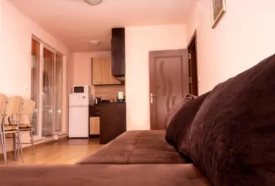 a living room with a couch and a kitchen at New Star Residence in Burgas City