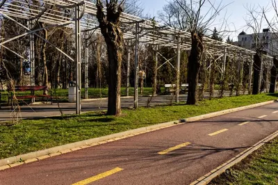 an empty road in a park with a white structure at New Star Residence in Burgas City